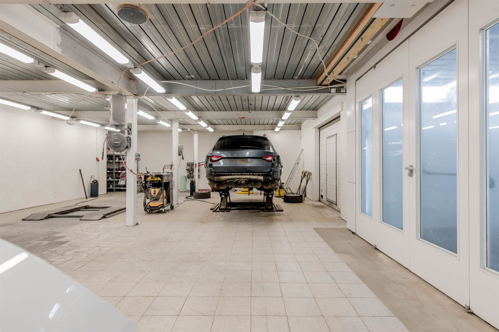 Collision-damaged vehicle in a repair bay