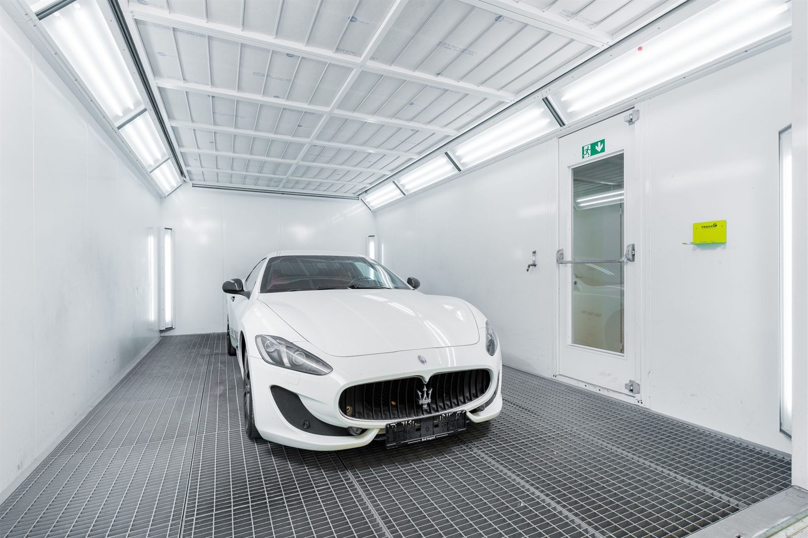 Car inside a lit spray booth