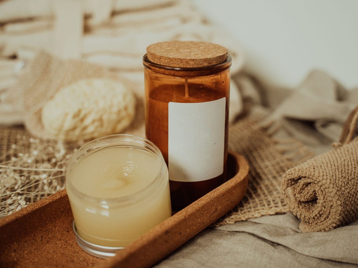Massage oils, a candle and folded towels in a calm treatment room