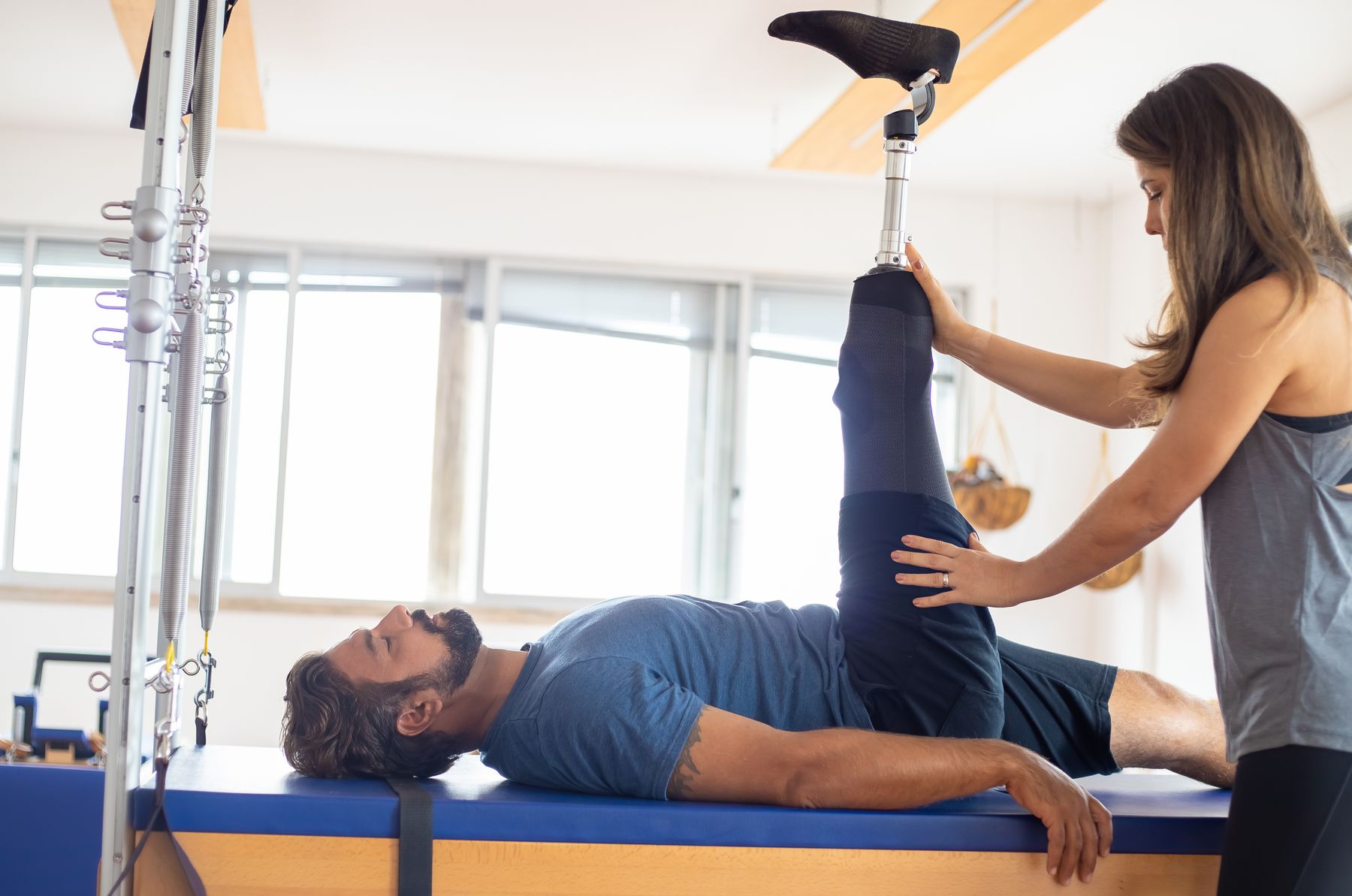 Biokineticist supervising a patient through a rehabilitation exercise