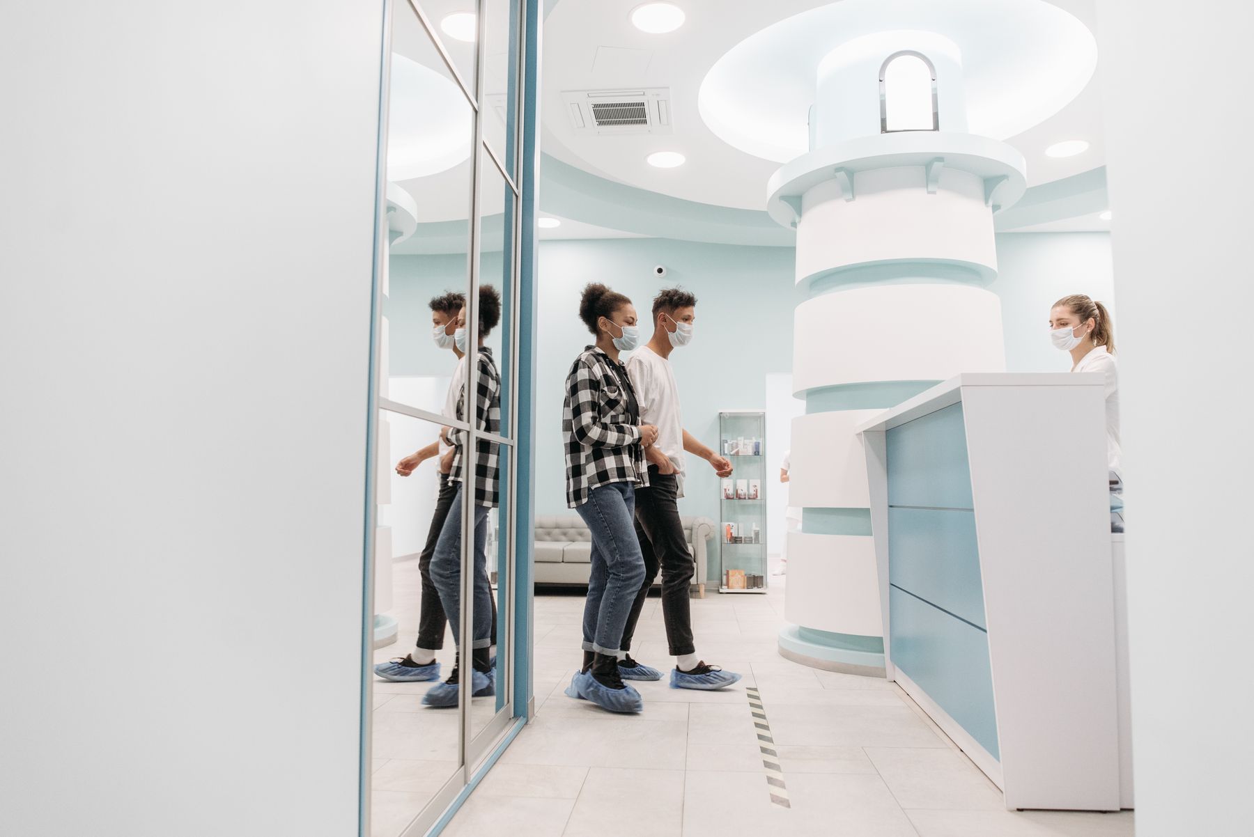 Patients arriving at the reception desk of a modern health practice