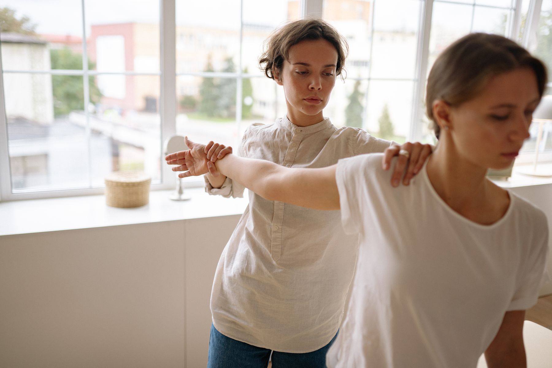 Physiotherapist treating a patient in a clinic treatment room