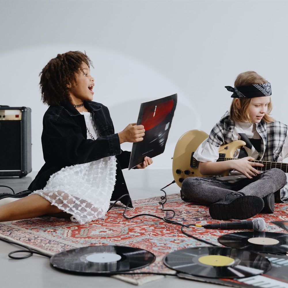 Children holding musical instruments during a music session