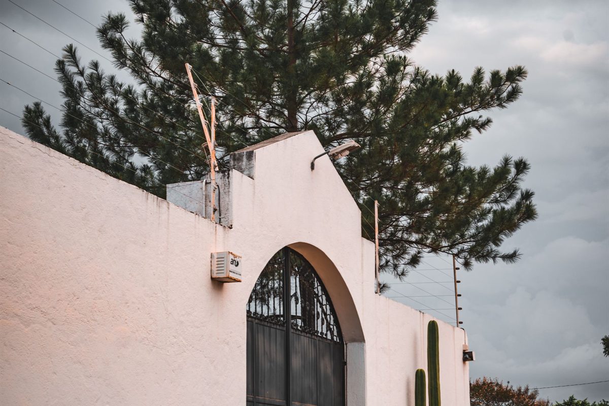 Boundary wall and gate with perimeter protection above it