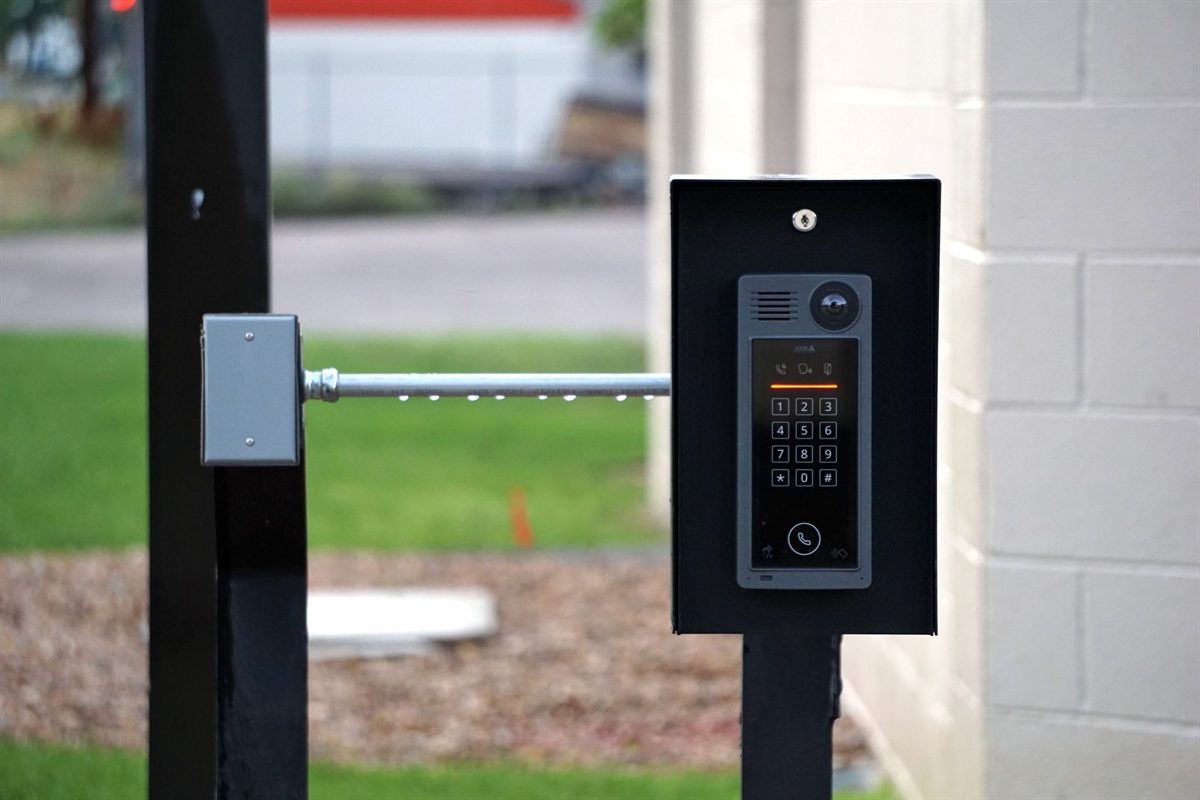 Intercom keypad and boom barrier at a property entrance