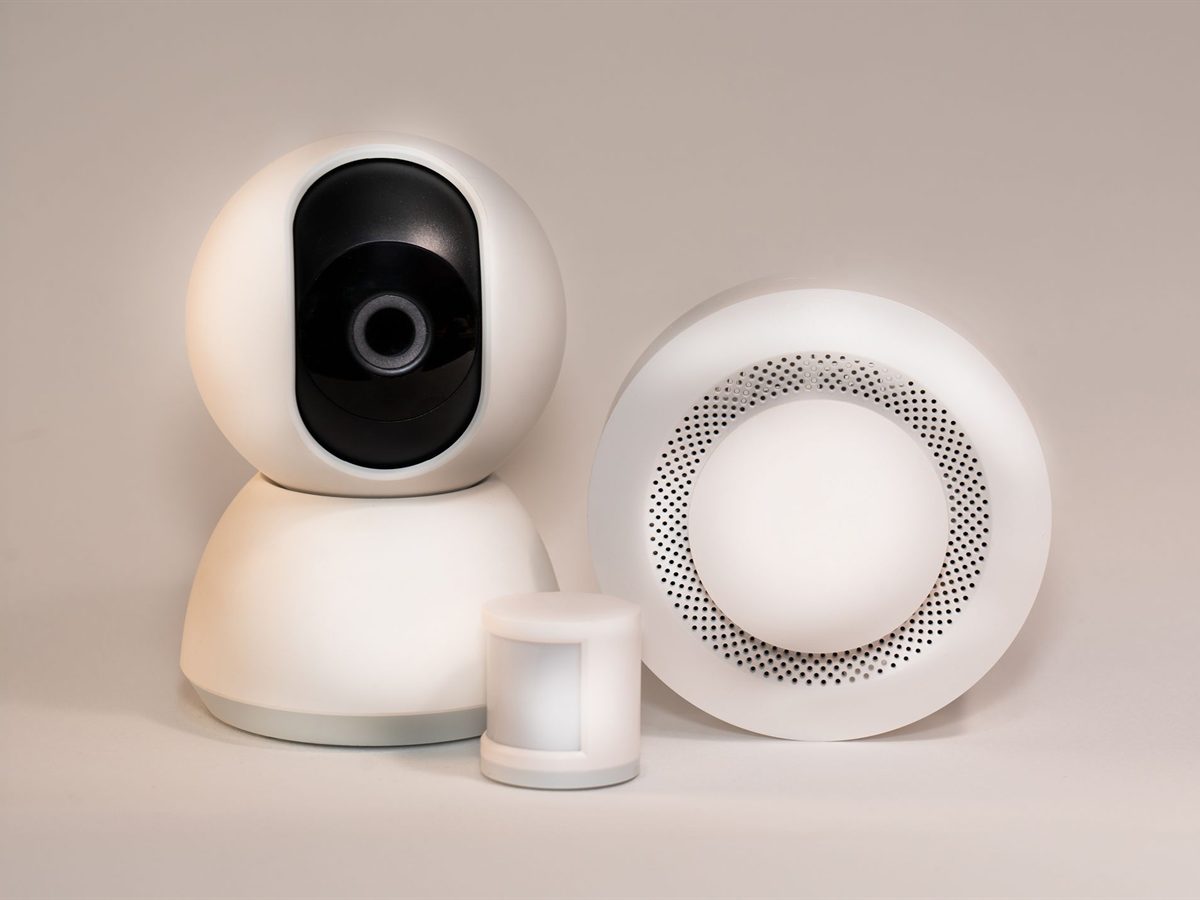 Alarm system components: siren, motion detector and indoor camera