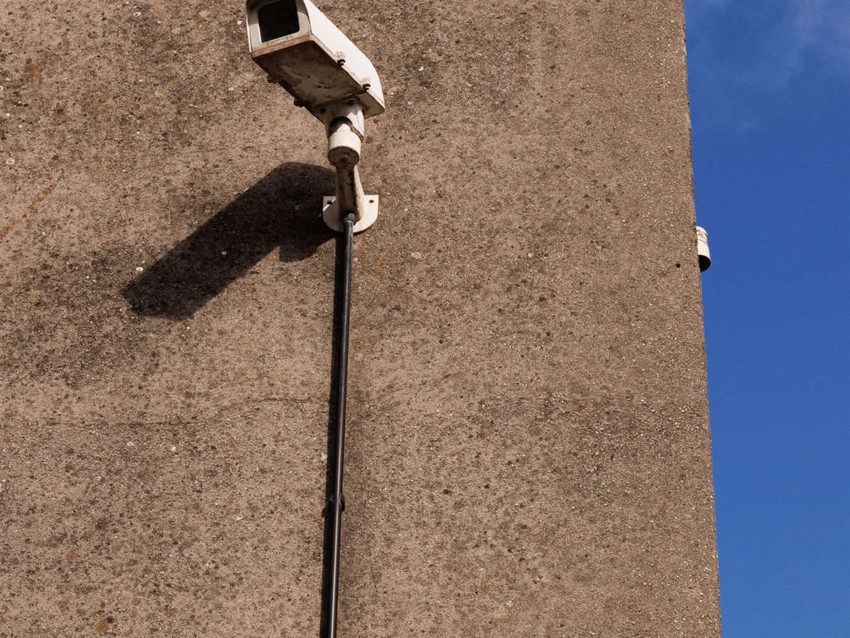 Outdoor security camera mounted on a sunlit wall