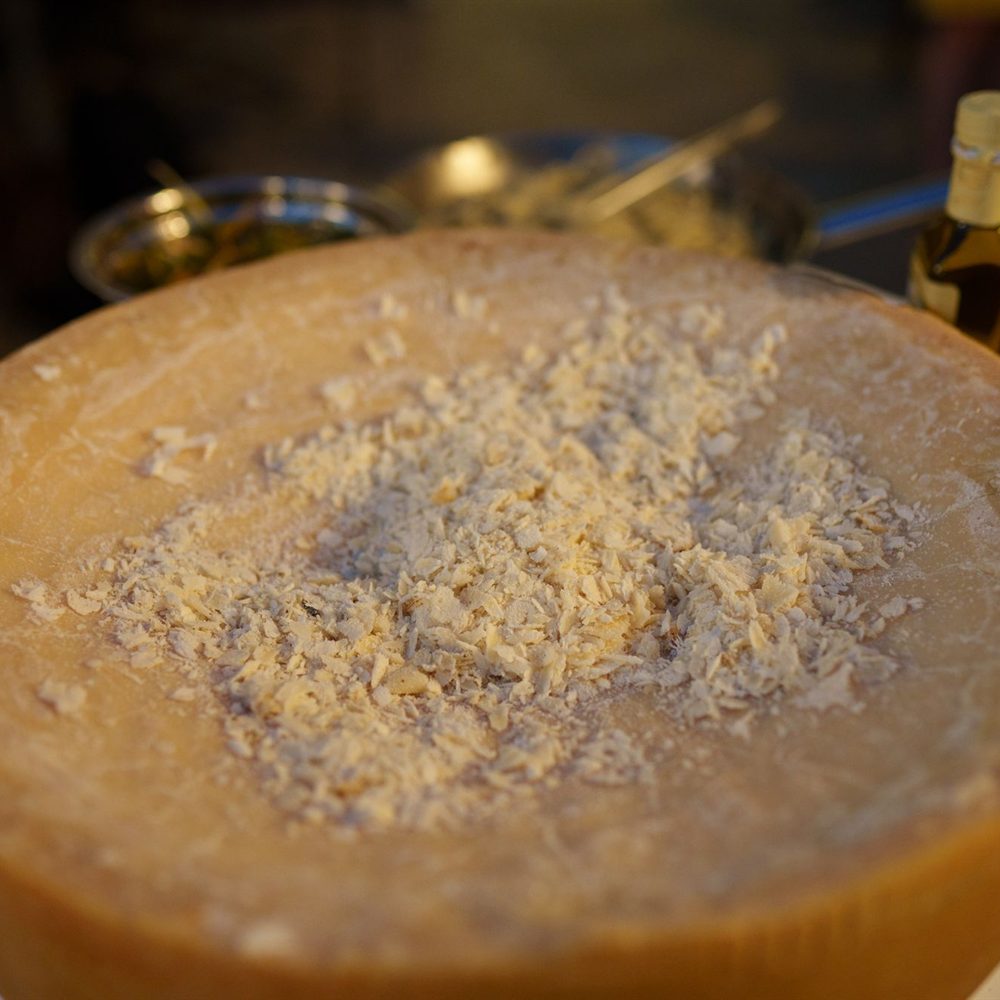 Wedge cut from a wheel of alpine-style farmhouse cheese
