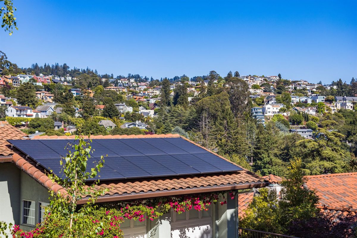 Roof-mounted solar panel array on a Cape Dutch style home