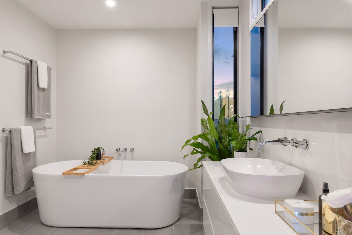 Freestanding bath with chrome wall-mounted taps