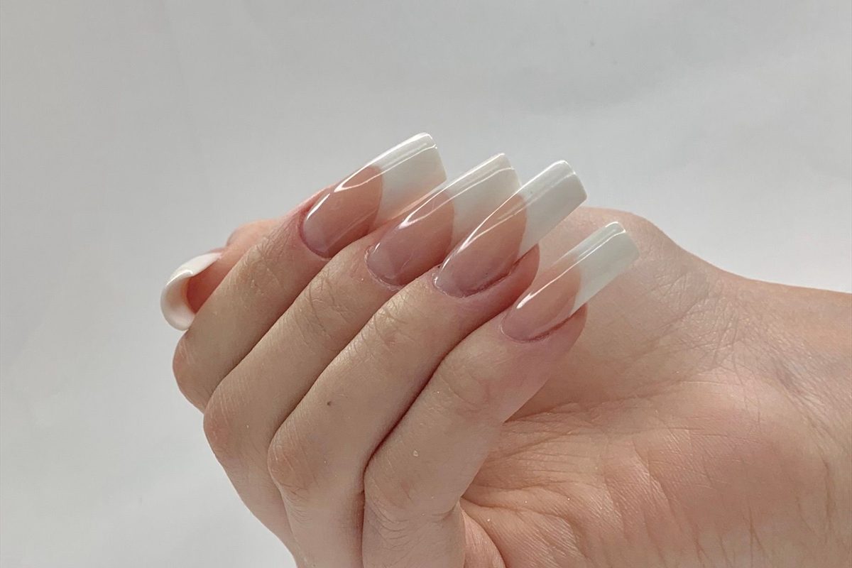 Finished pedicure with a soft neutral polish