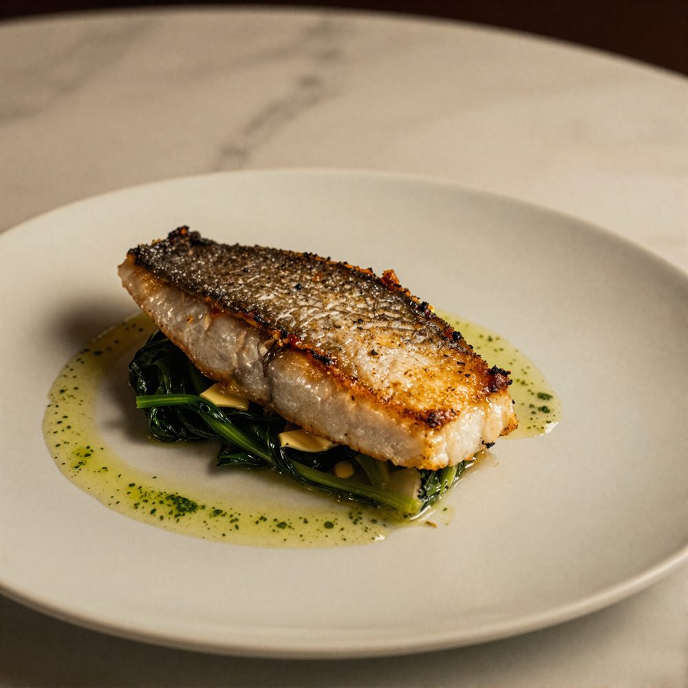 Pan-fried sea bass with buttered greens and samphire