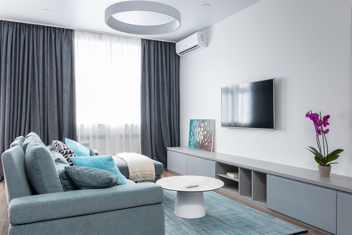 Wall-mounted split air conditioning unit in a living room