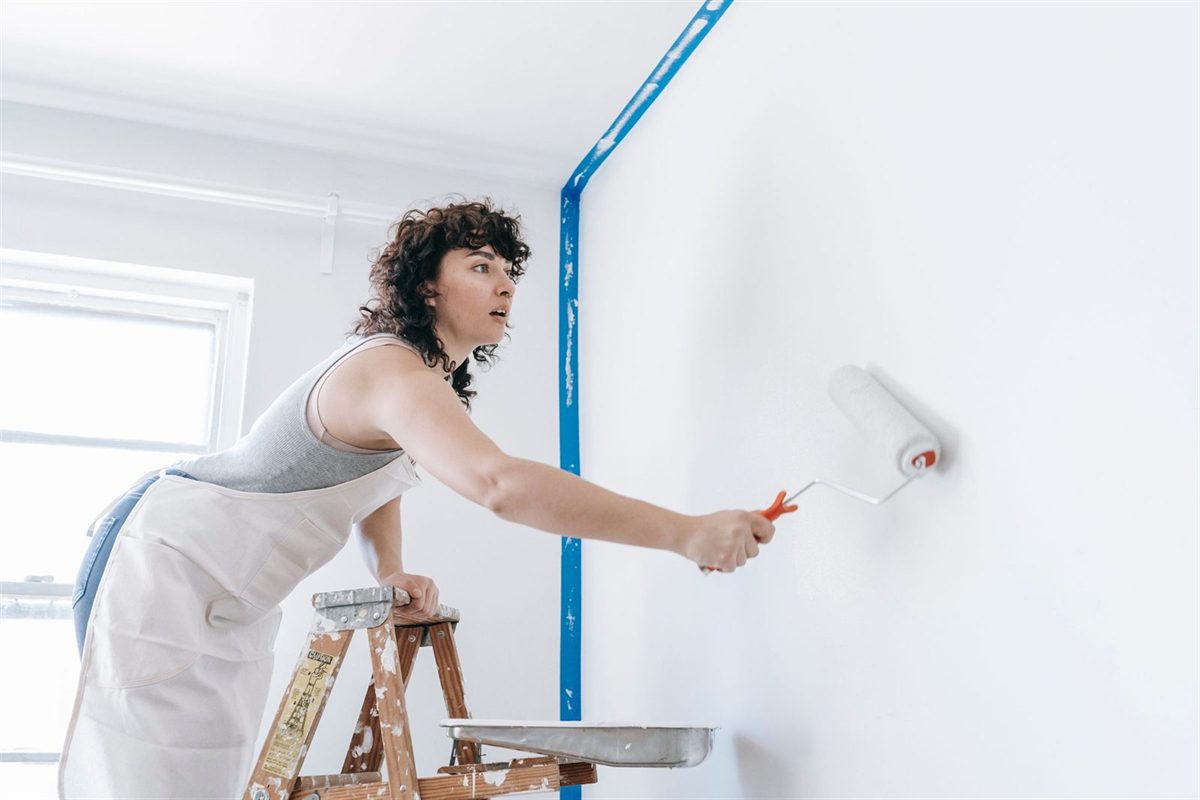 Decorator painting an interior wall