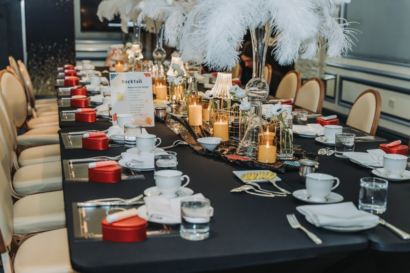 A long banquet table laid with candles and white flowers