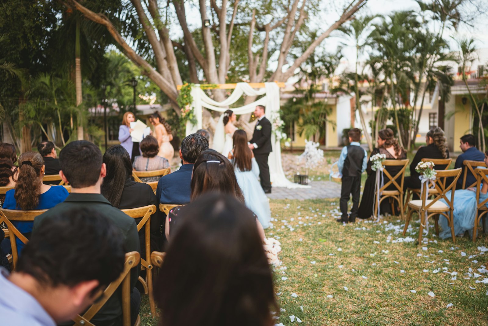 A wedding ceremony outdoors with guests seated in rows