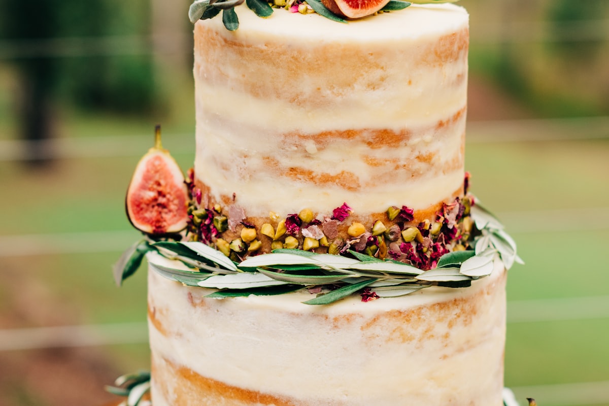 A three-tiered cake decorated with figs