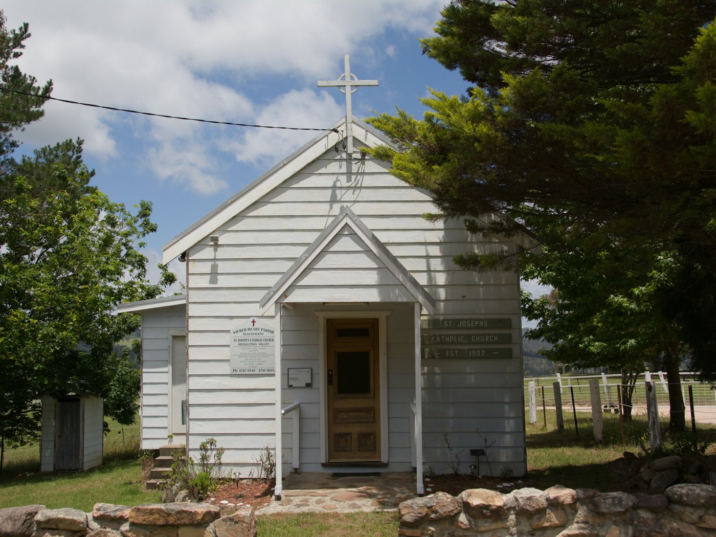 A small whitewashed chapel with a cross above its gable