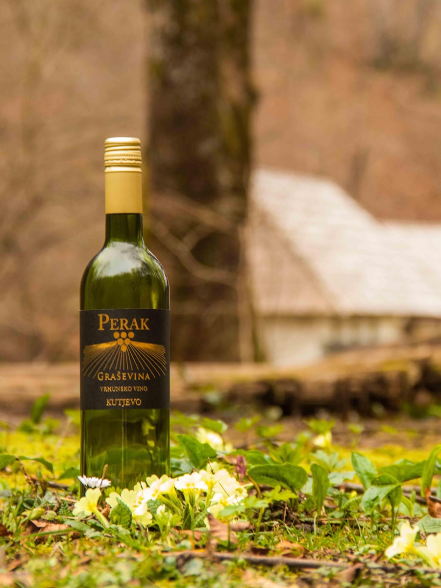 A bottle of wine standing in long grass
